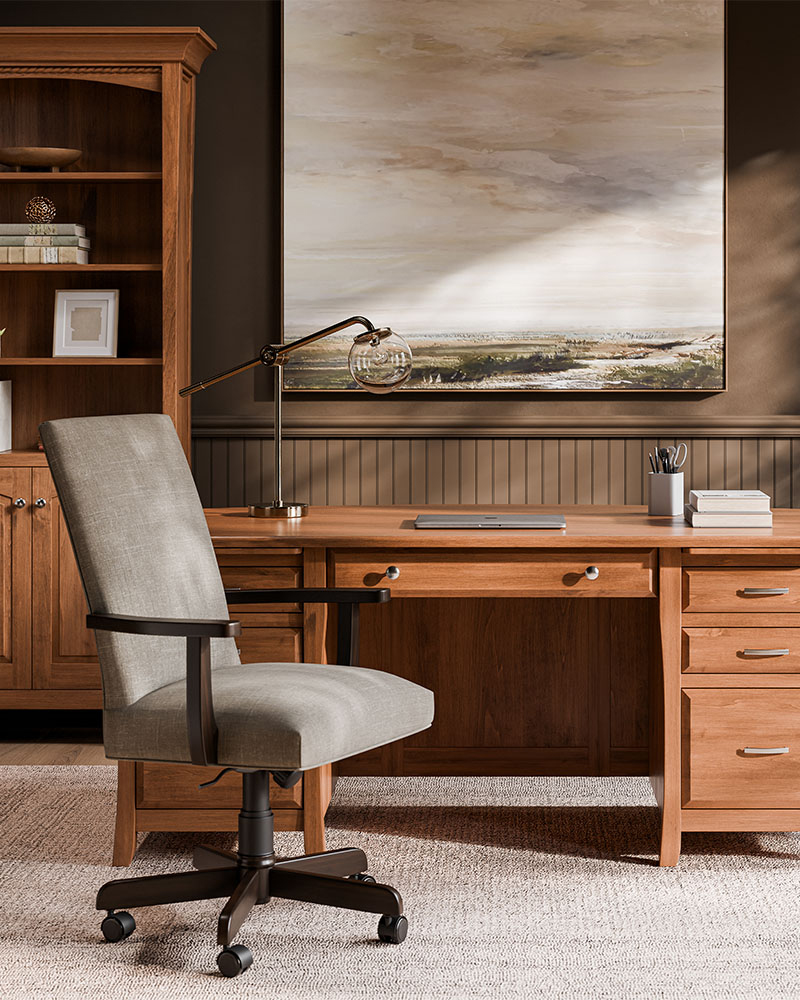 Solid wood office desk with upholstered swivel chair and matching bookcase